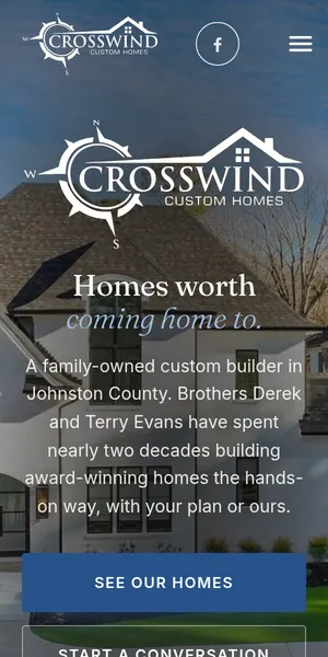 The Crosswind Custom Homes site on a phone: their logo over a finished home